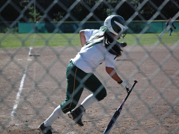 Freshman Leilani Huey drops her bat to sprint for first base. 