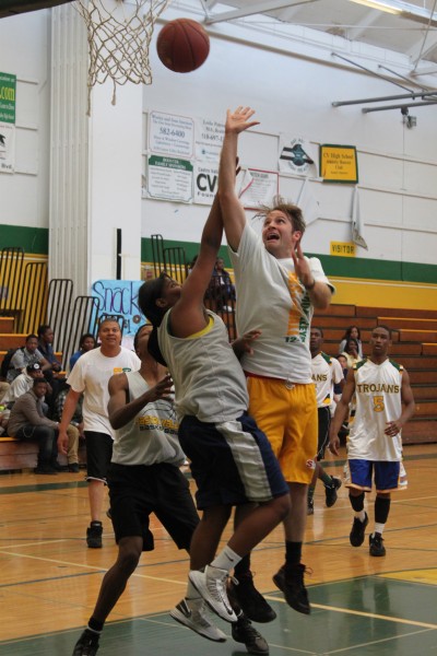 English teacher Josh Linville takes a shot as student tries to block his attempt. 