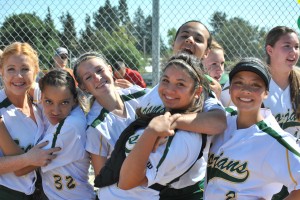 The girls varsity softball team smiles amidst its loss. Photo by Adrianna Vandiver.