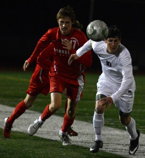 Castro Valley's Josh Guzman (right) races a Yellow Jacket for the ball. Photo by Jes Smith.