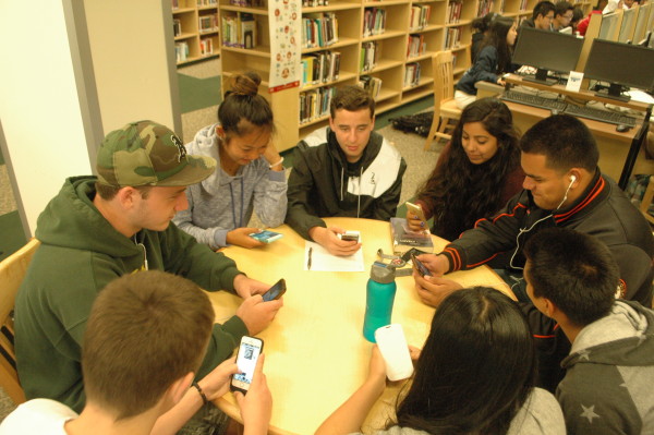 Students play on their phones while other students slave during the SBAC. Photo by Laniah Lewis.