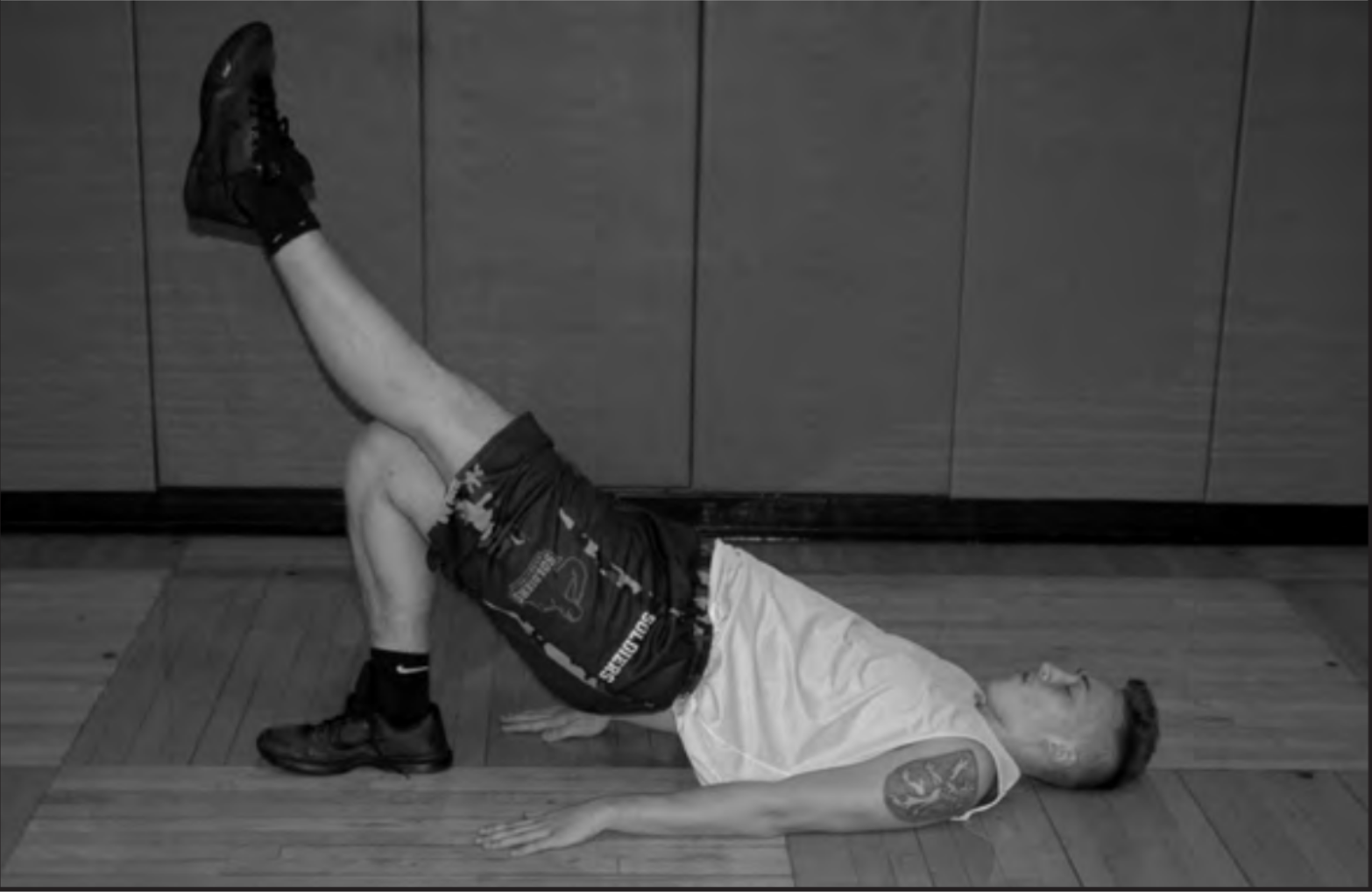 Athlete Thomas Faustka warms up by stretching his back before practice to prevent another fracture in his back. Photo by Caitlin Forbes