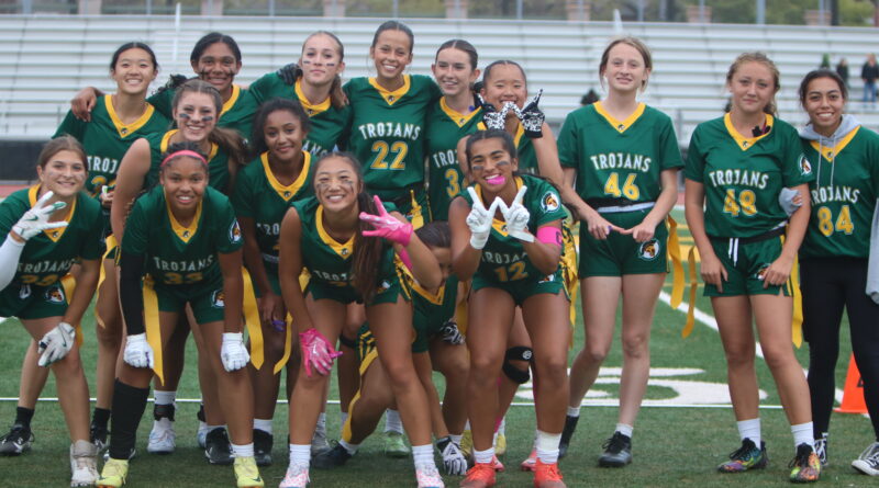 The girls flag football team pose for a group picture