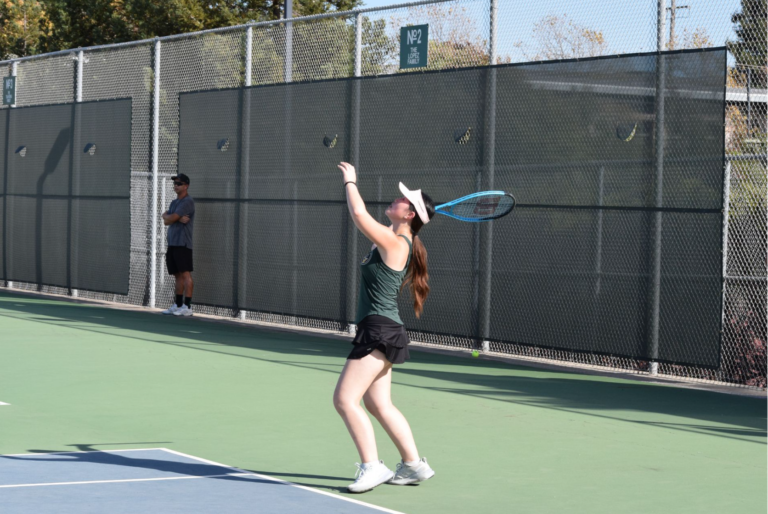Angel Jiang lifts up the racket to hit the ball. Photo by Alisa Wang